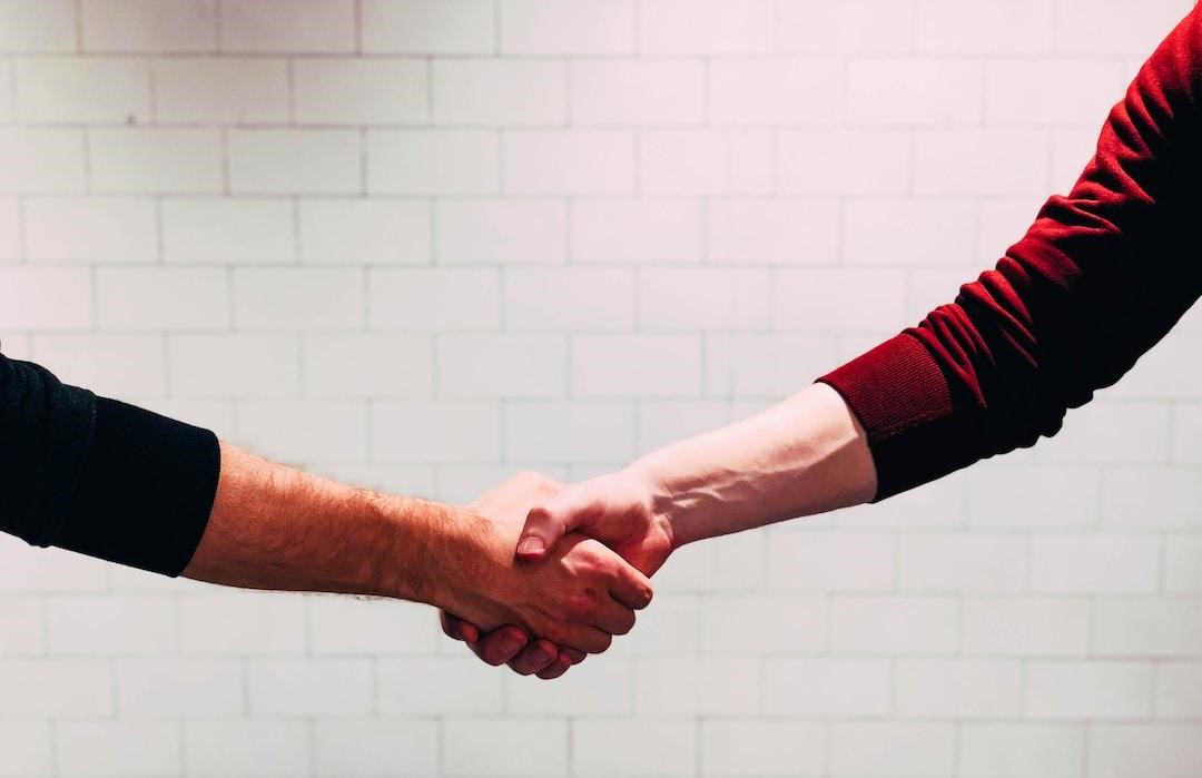 A customer and a business owner shaking hands